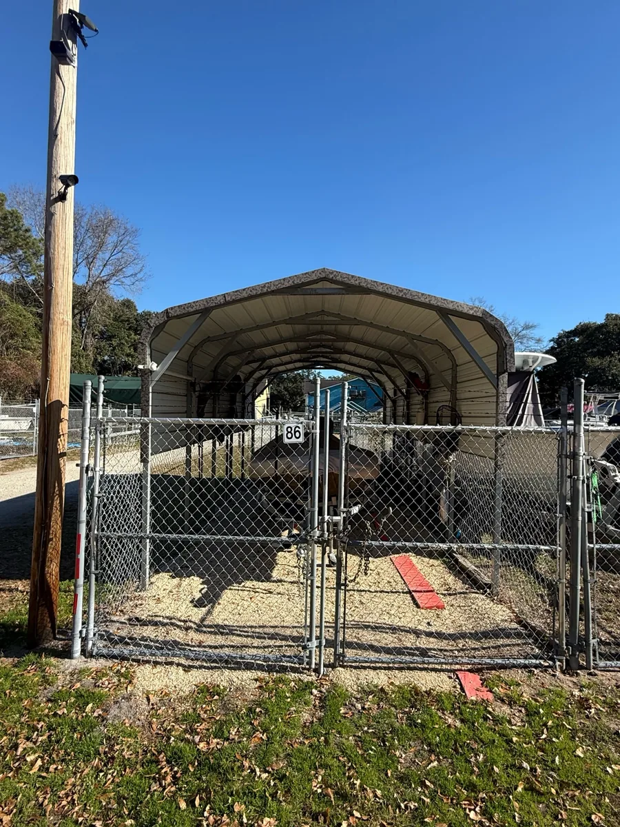 Covered storage shelter behind the individual gate of space 86